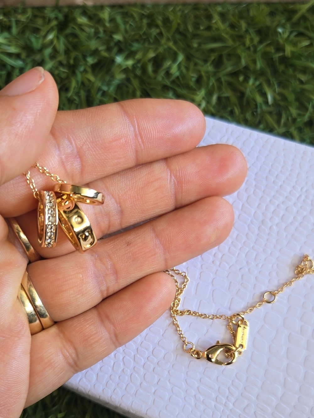 Coach Gold Tone Triple Ring Pendant Necklace with Crystal Accents